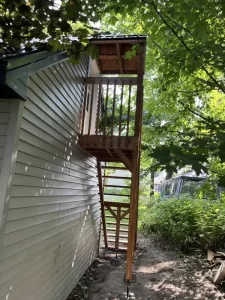 Nouvelle construction d'un escalier extérieur en bois adjoint à une maison, reflétant l'expertise de Construction MFA dans les solutions d'accès personnalisées.